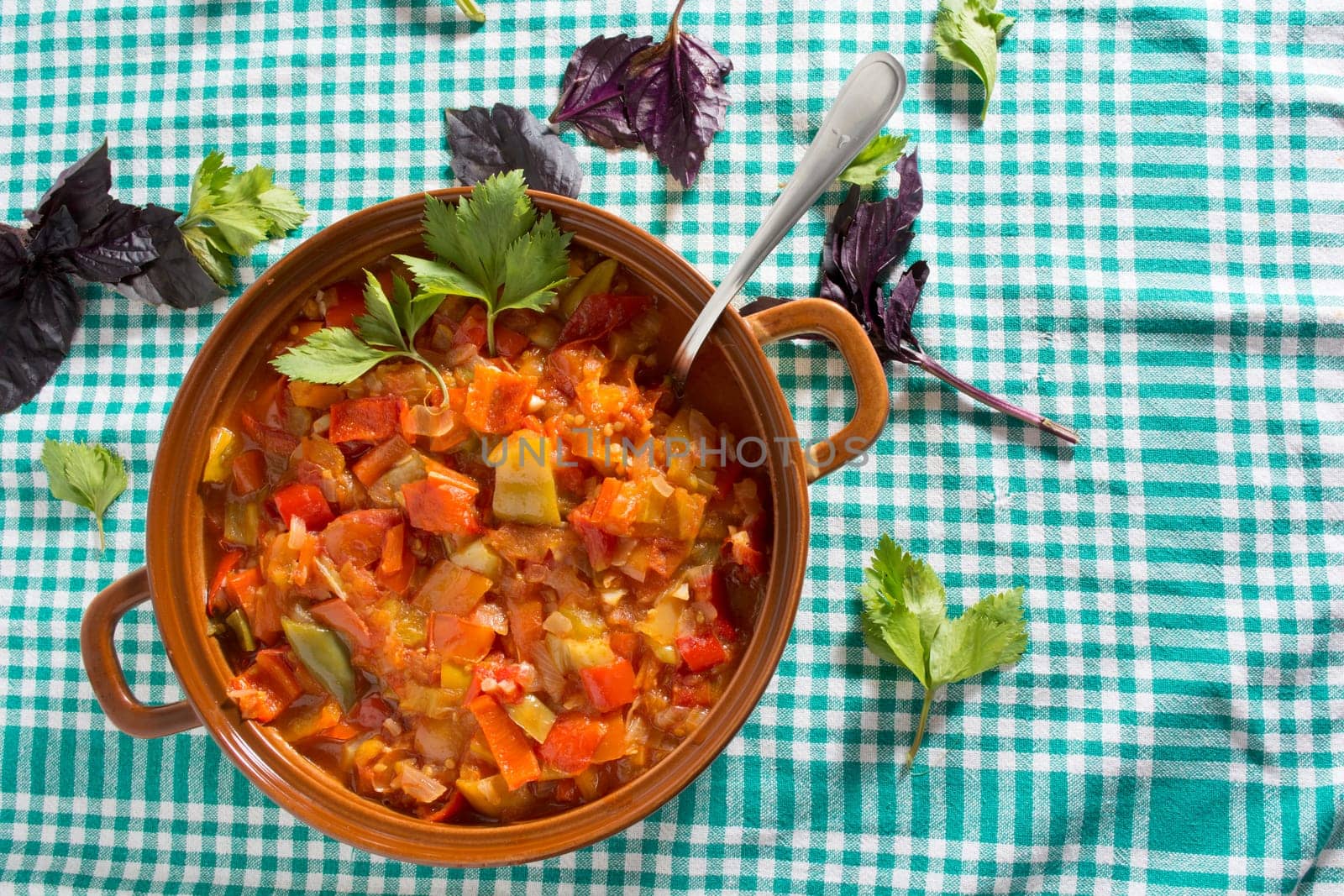 Closeup of delicious stew with mixed vegetables, arranged with green and purple leaves