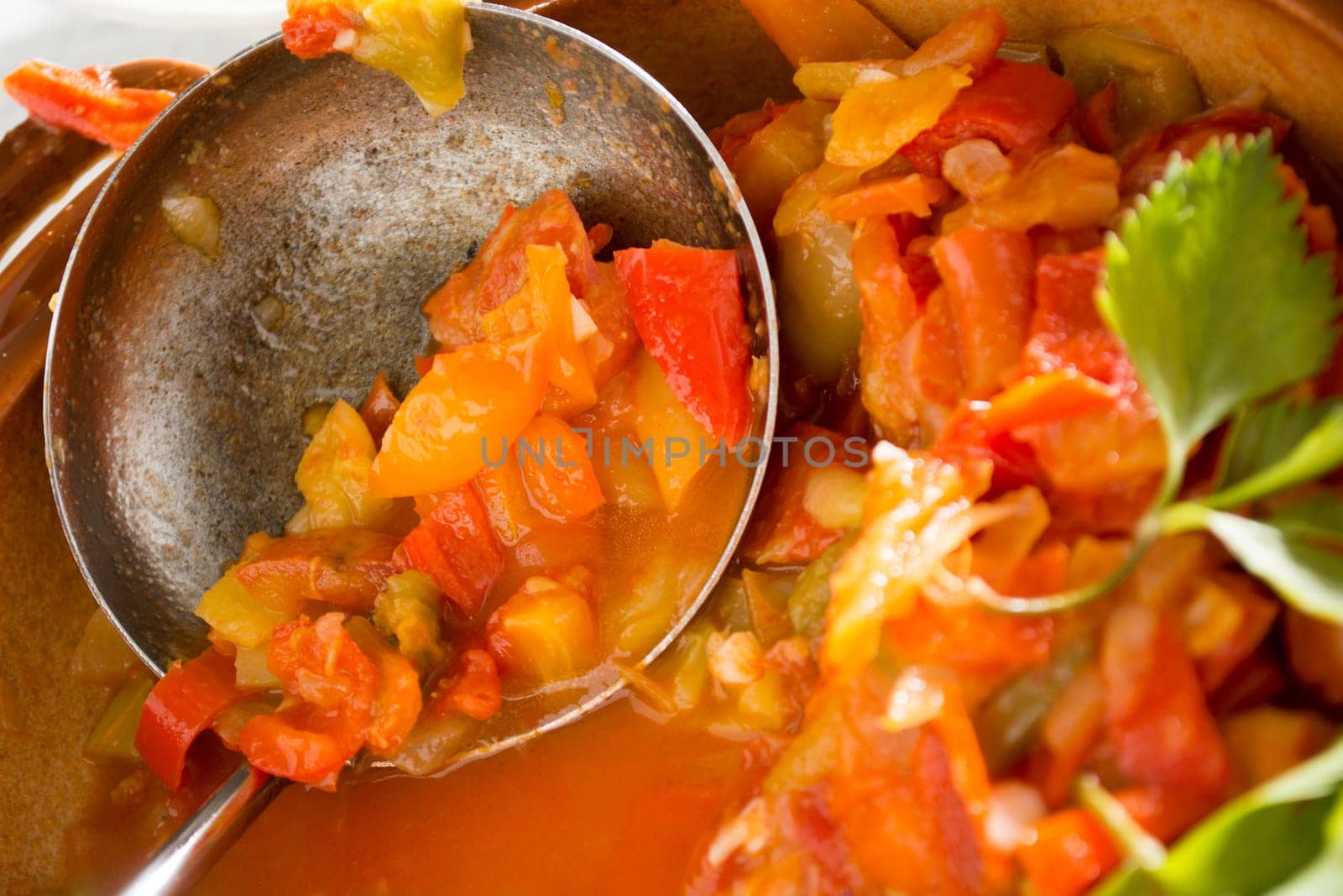 Closeup of vegan stew, half eaten with ladle