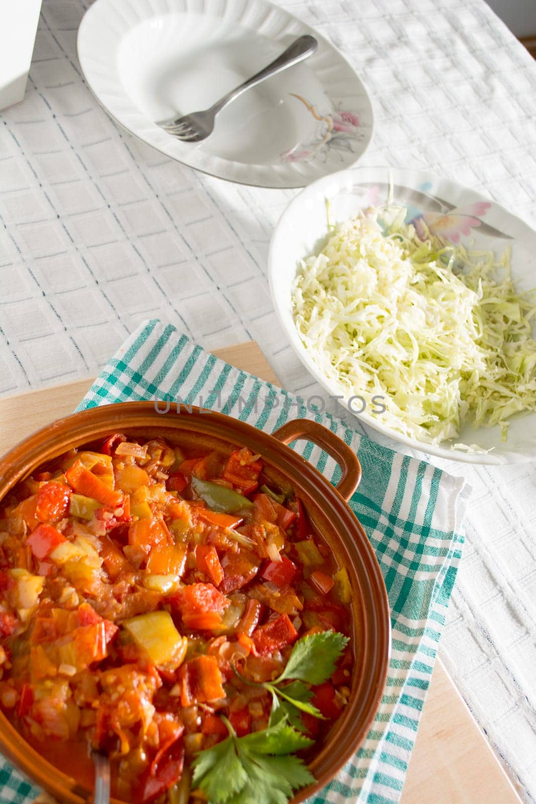 Stewed vegetables on a table with salad