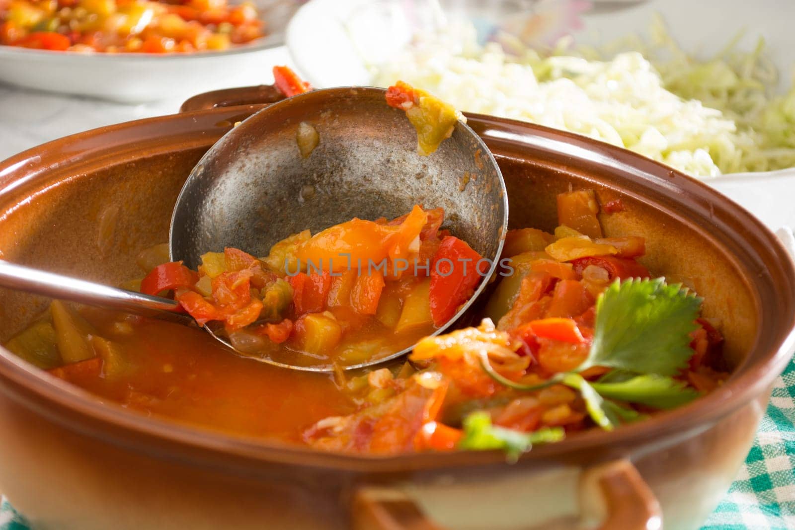 Closeup of vegan stew, half eaten with ladle