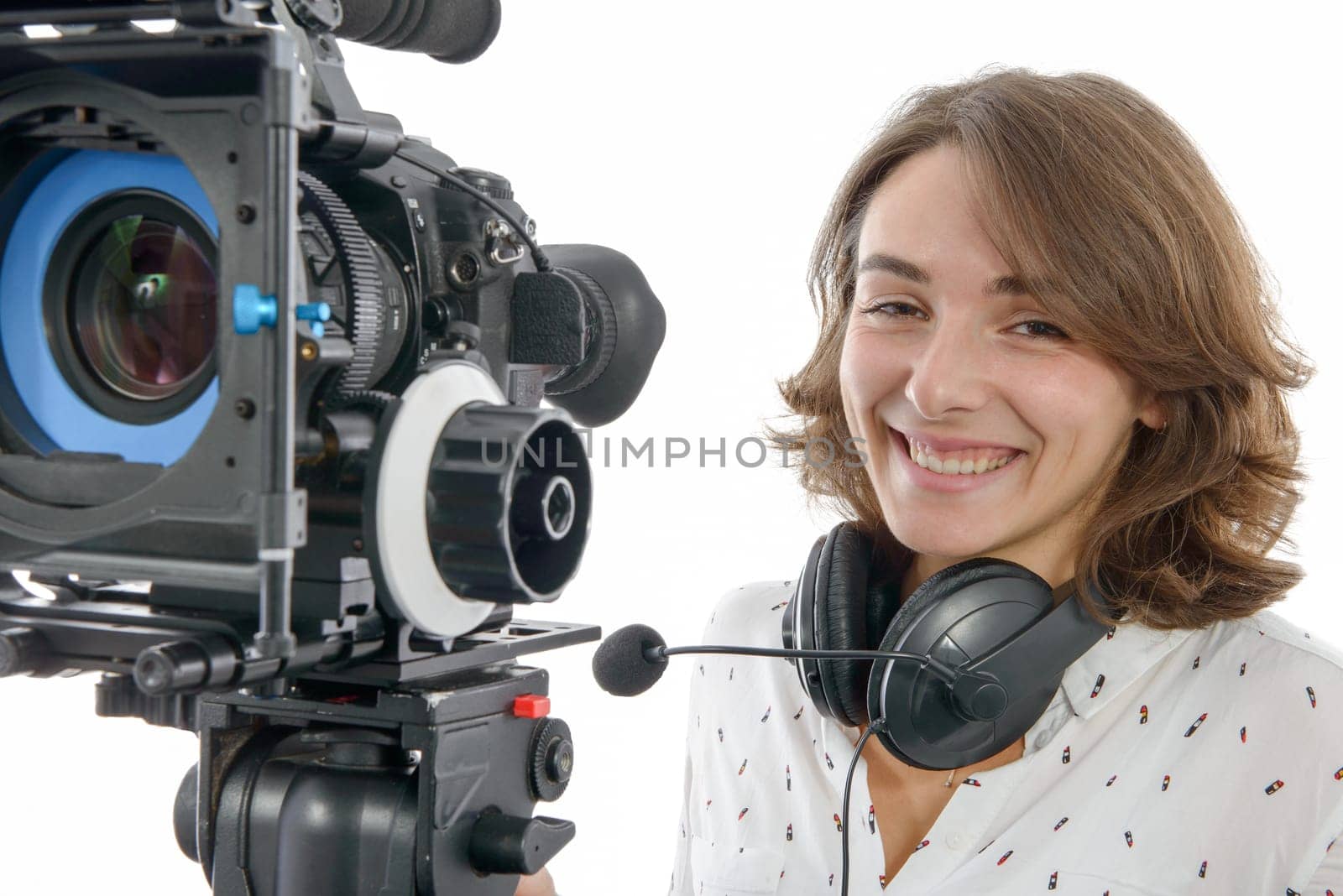 beautiful young woman with DSLR video camera and headphones