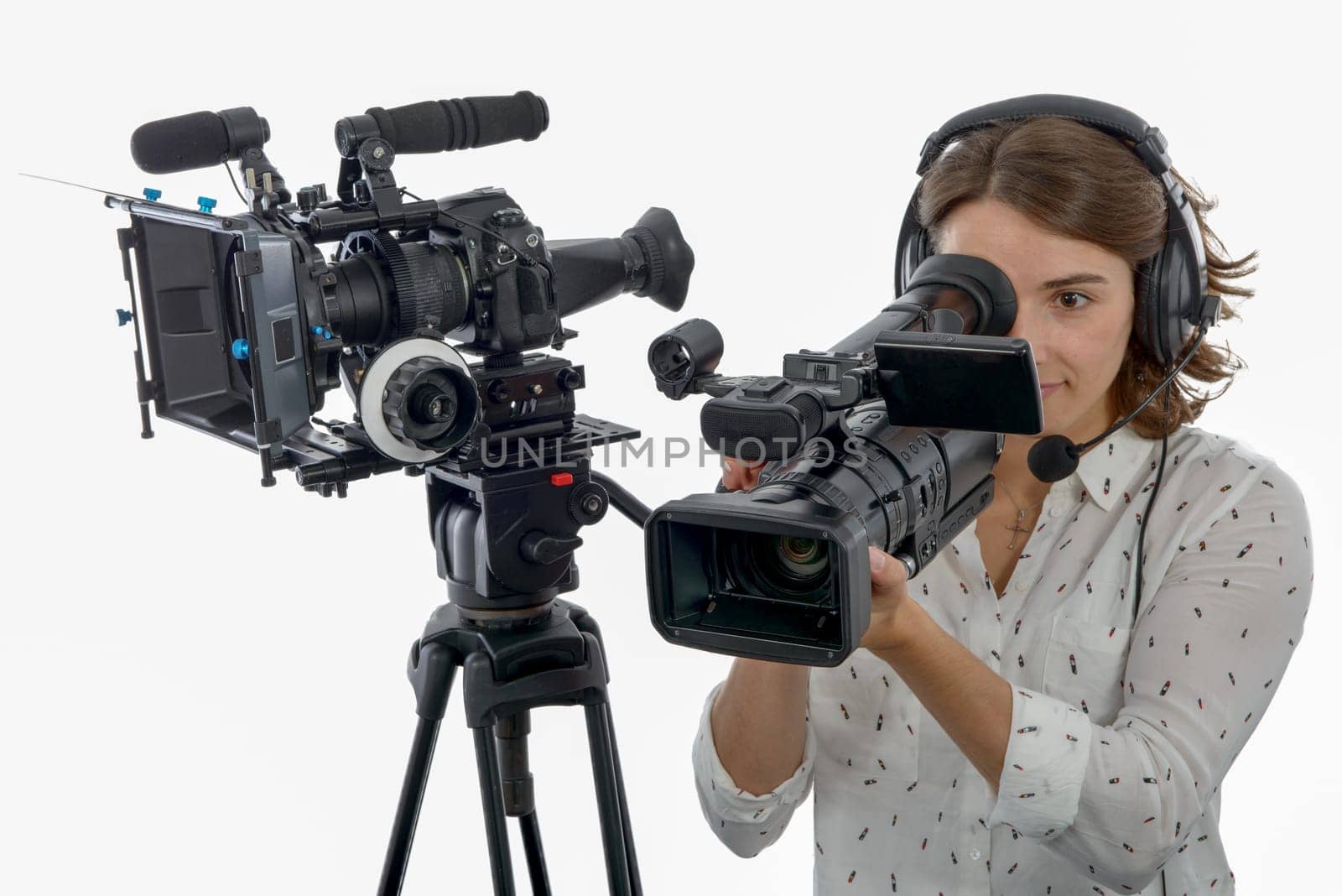 pretty young  girl with a professional camcorder, on white