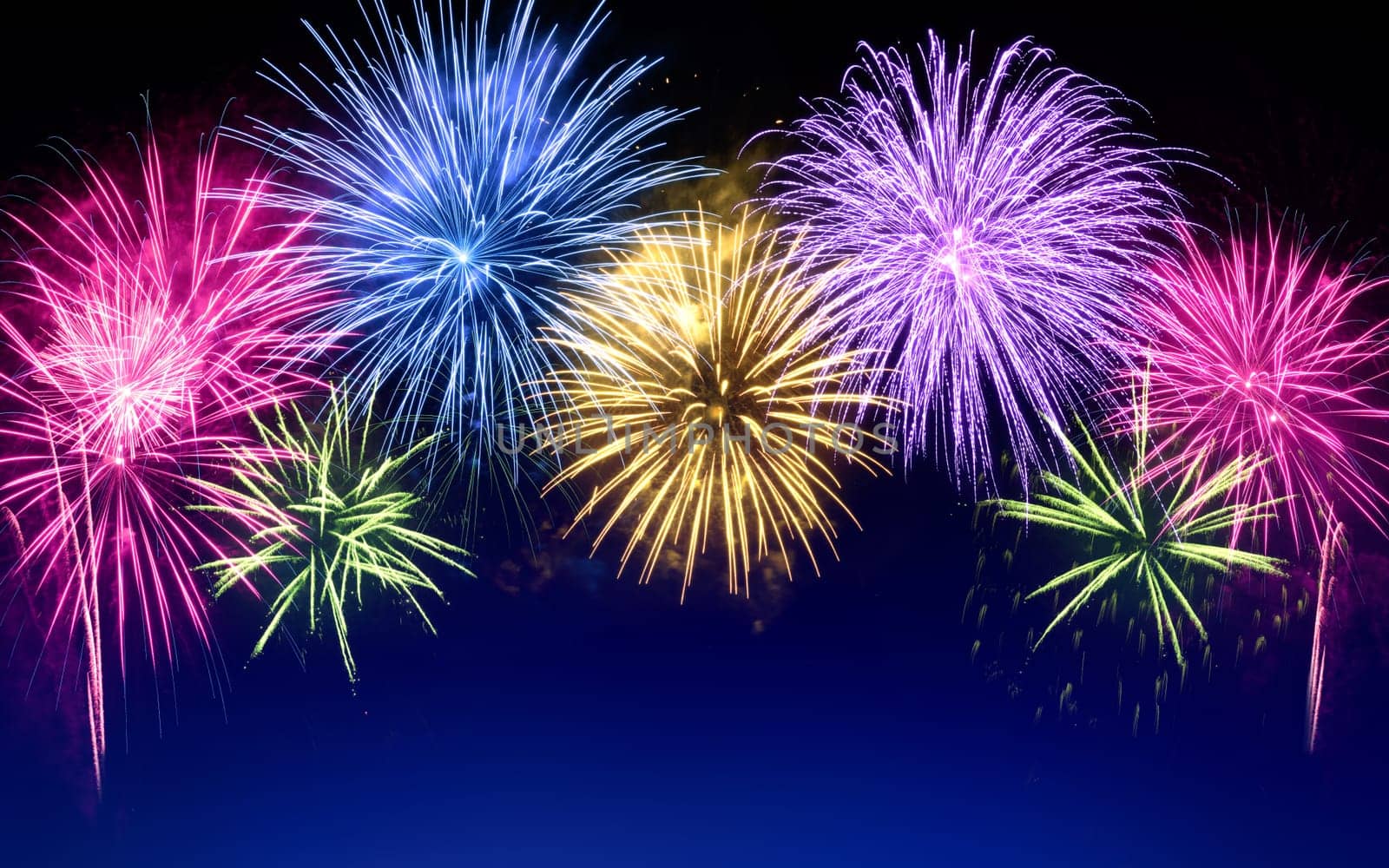 Gorgeous multi-colored fireworks as an arch shaped border on dark blue background,ideal for New Year or other celebration events