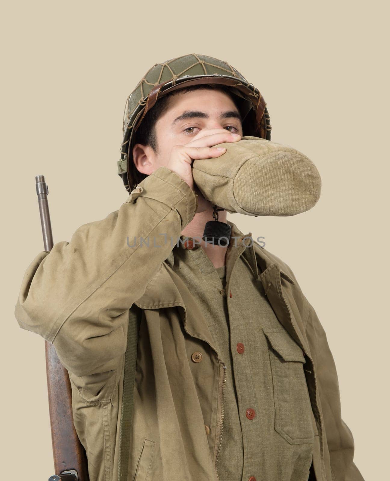 young American soldier drink water in his can, world war two