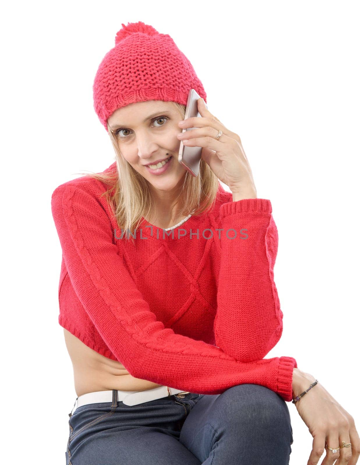 Beautiful young blonde woman with a red cap, talking on the phone