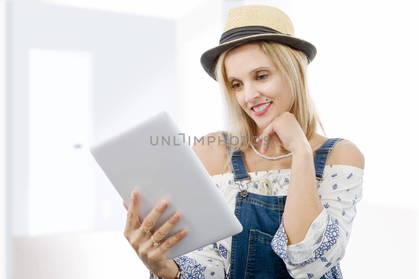 beautiful blond middle-aged woman with tablet computer
