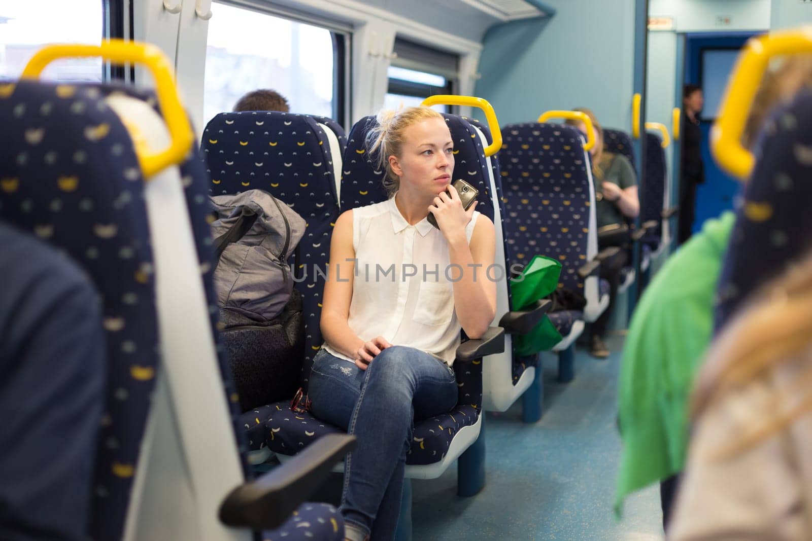 Young woman looking trough window while traveling by train.