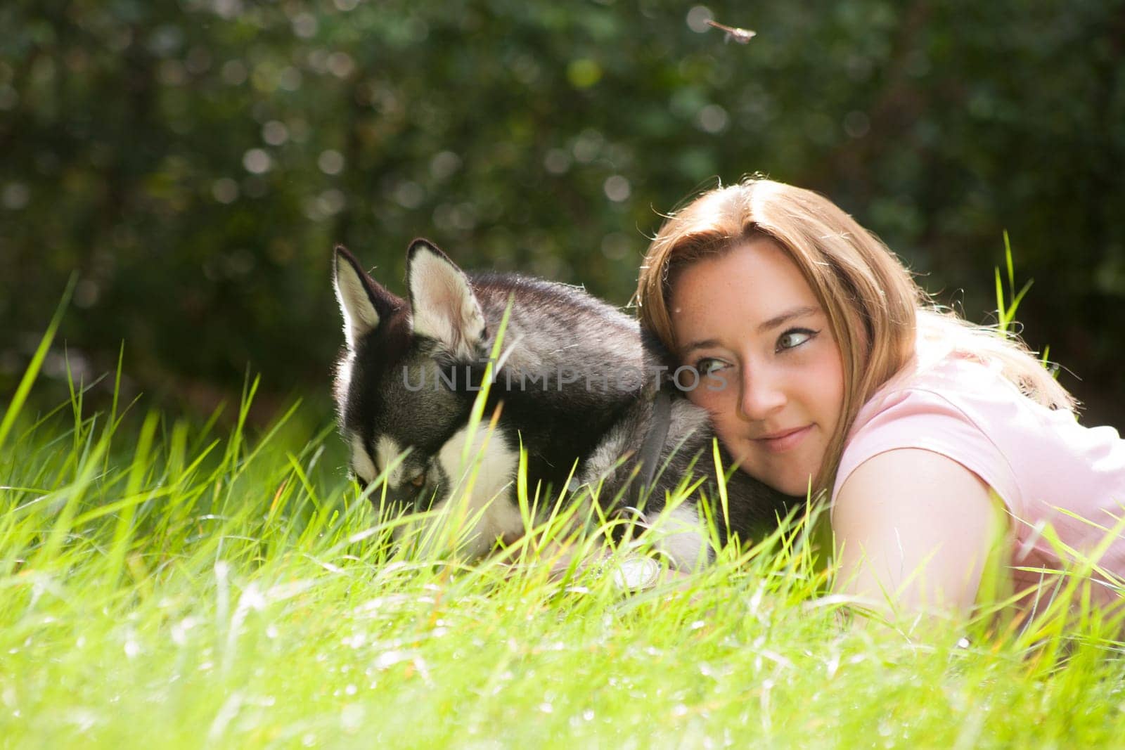 Young woman and her husky in the forest
