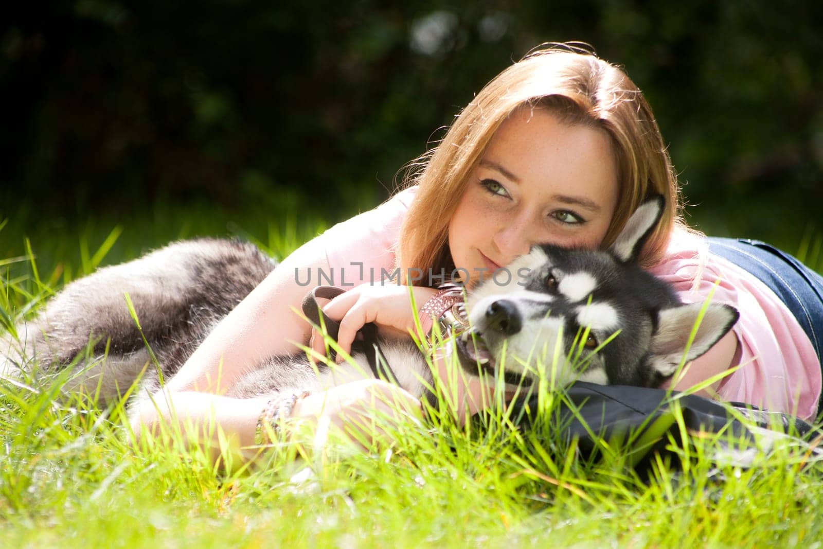 Young woman and her husky in the forest