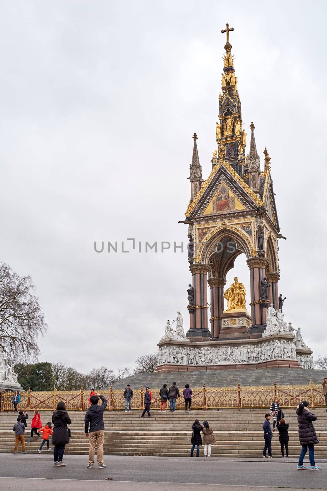 LONDON, UK - DECEMBER 17: Tourists taking pictures in front of the Albert Memorial in Kensington Gardens. December 17, 2014 in London.
