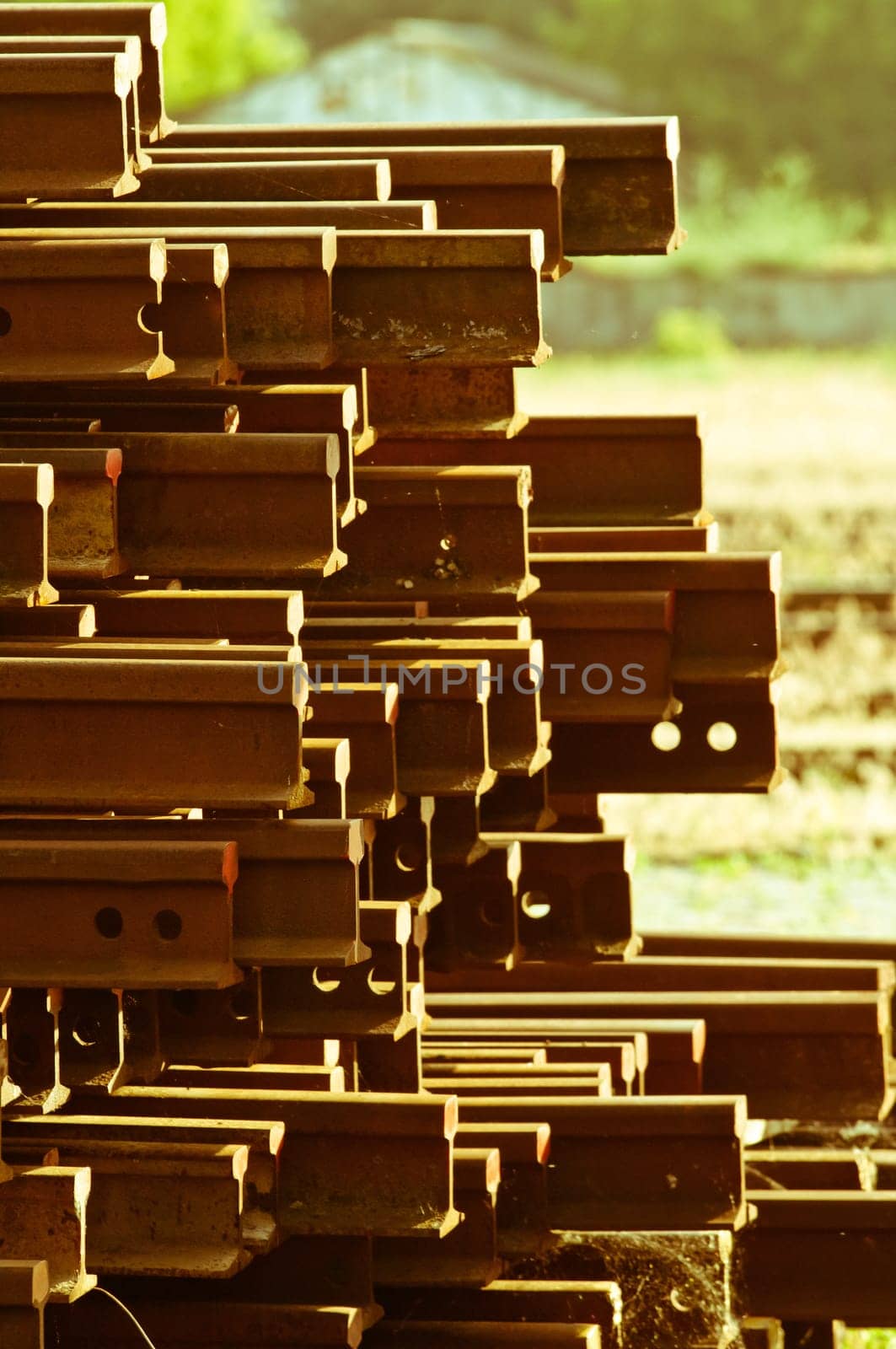 Stack of rusty railway tracks beside the track