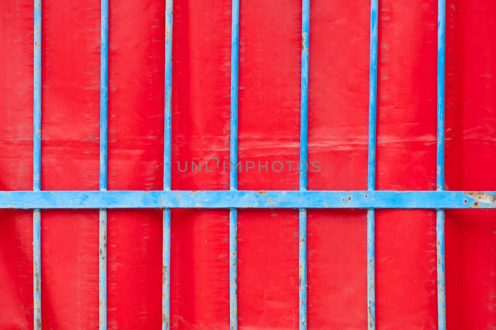 Blue iron fence and red background