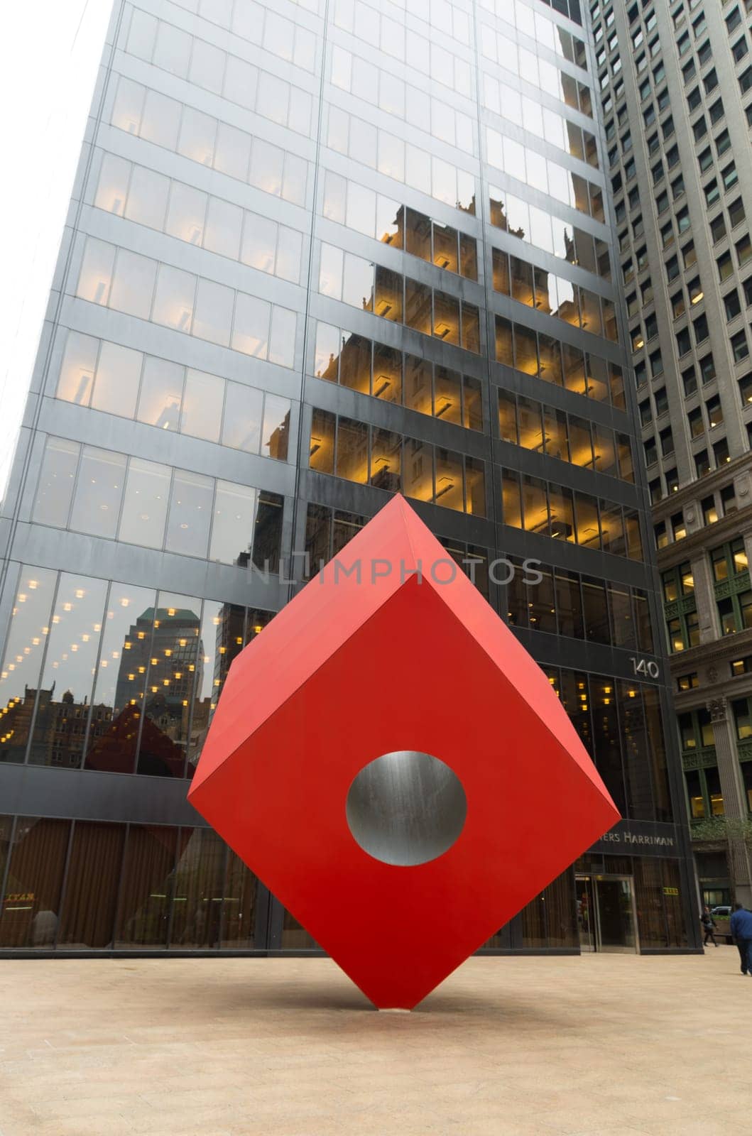 NEW YORK - MAY 2, 2016: Noguchi's Red Cube in front of the HSBC bank building