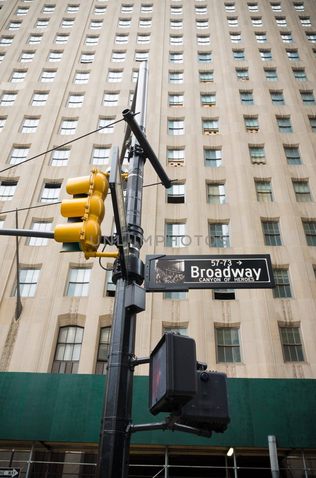 broadway street sign with yellow traffic lights in new york city