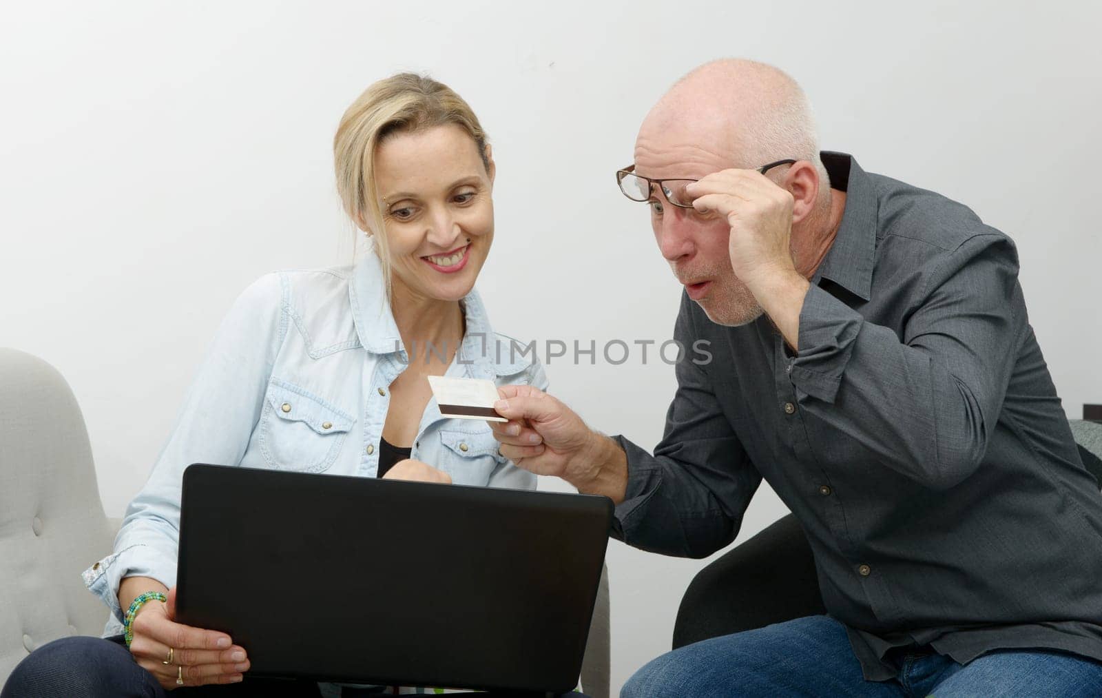 mature couple e-shopping on internet at home