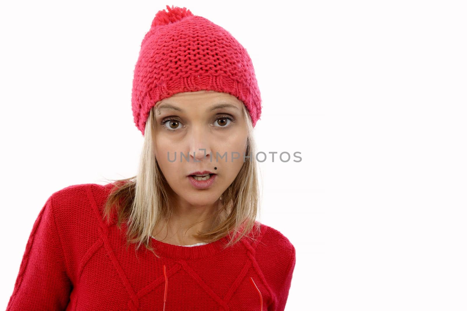 Beautiful young blonde woman with a red winter hat isolated on white background