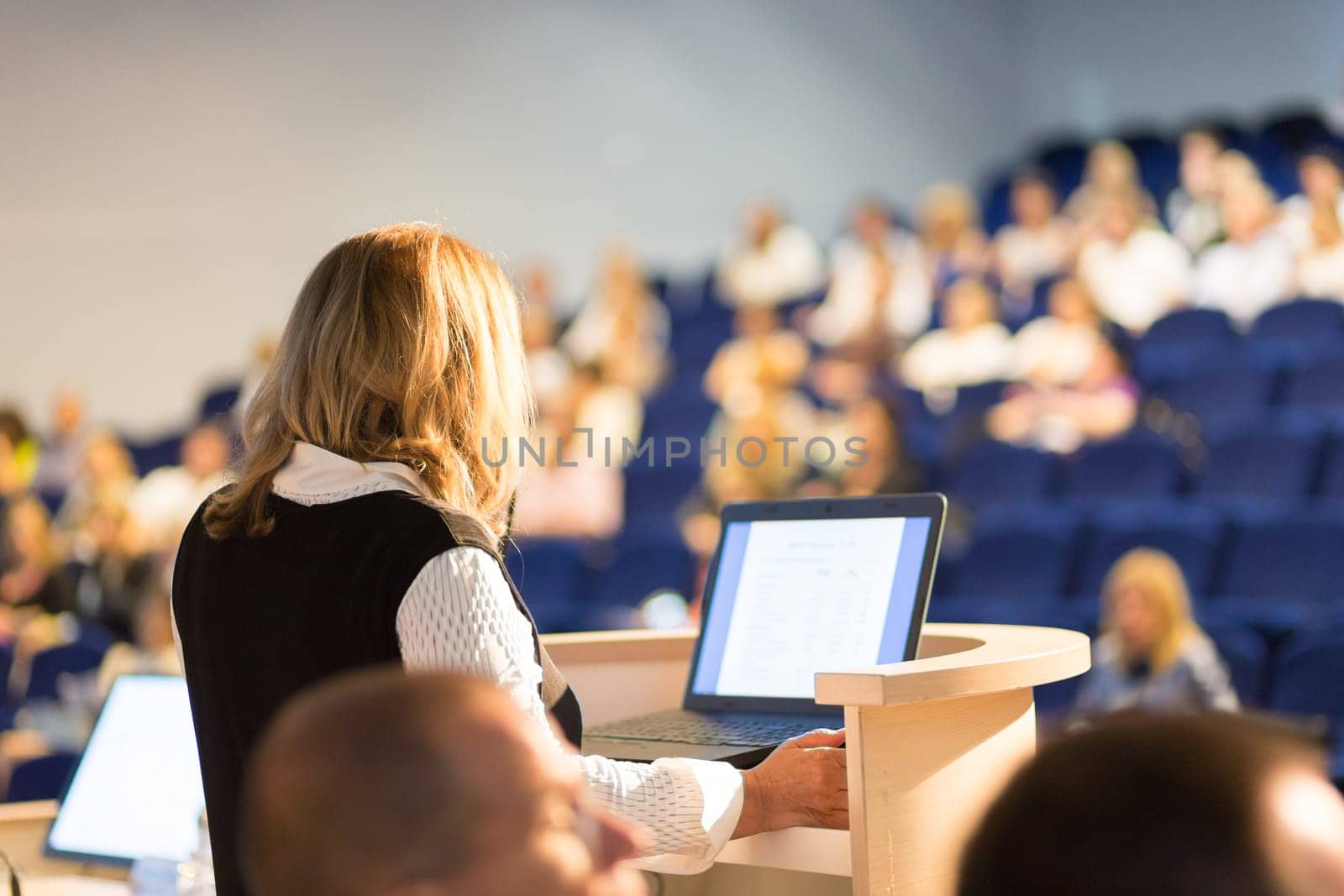 Female speaker at Business Conference and Presentation. Audience at the conference hall. Business and Entrepreneurship. Business woman. Horizontal composition.