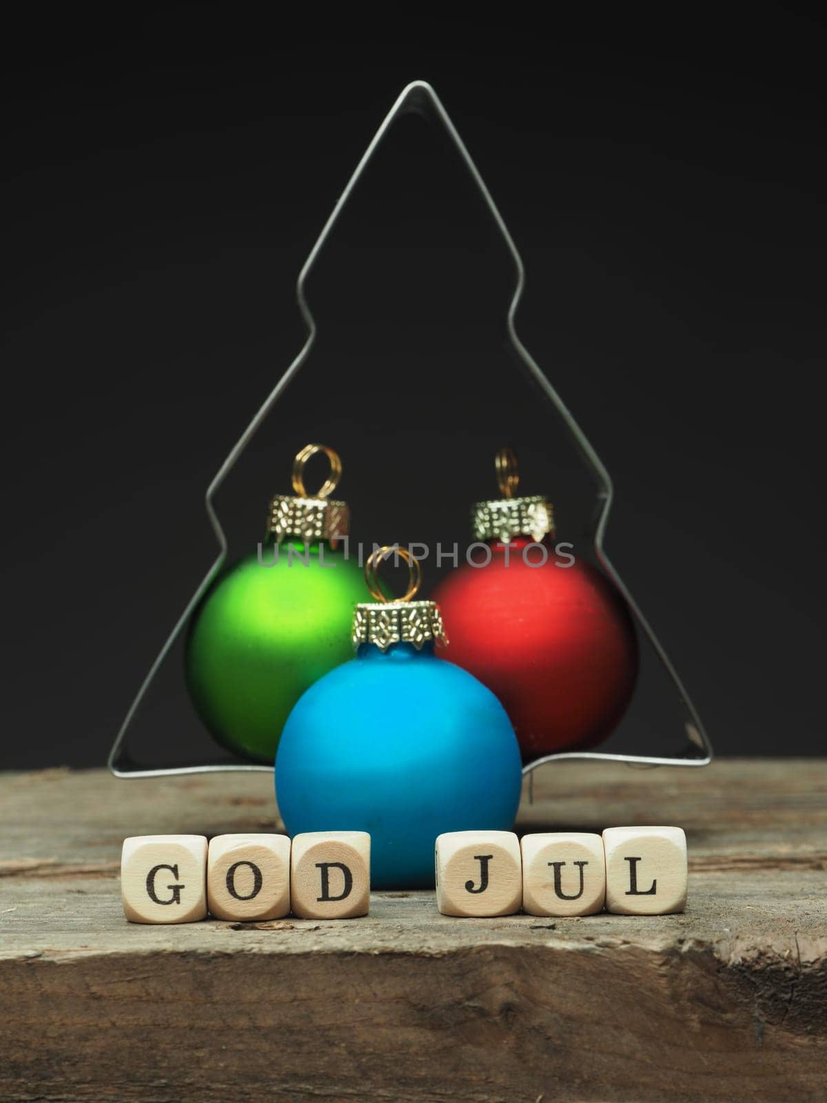 Baking tin tree shape with small wooden dices and the words God Jul, Scandinavian Merry Christmas