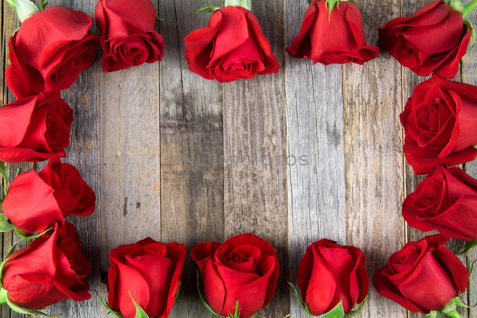 Romantic red rose frame for a special occasions on a wooden background with copy space.