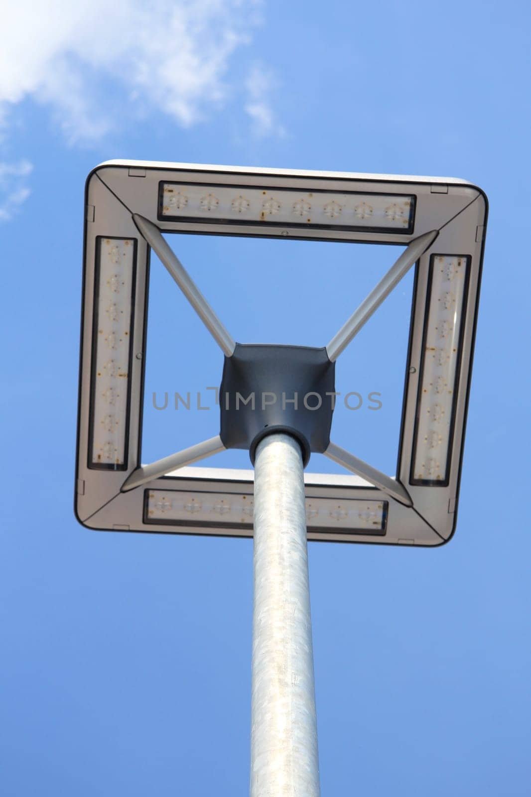A street lamp with a blue sky in the background.