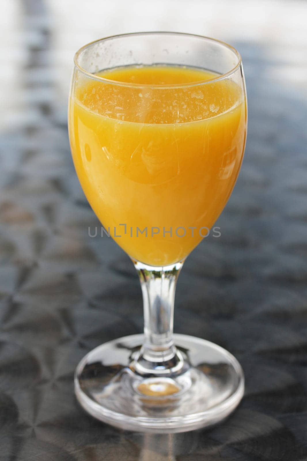 A glass filled with fruit juice.