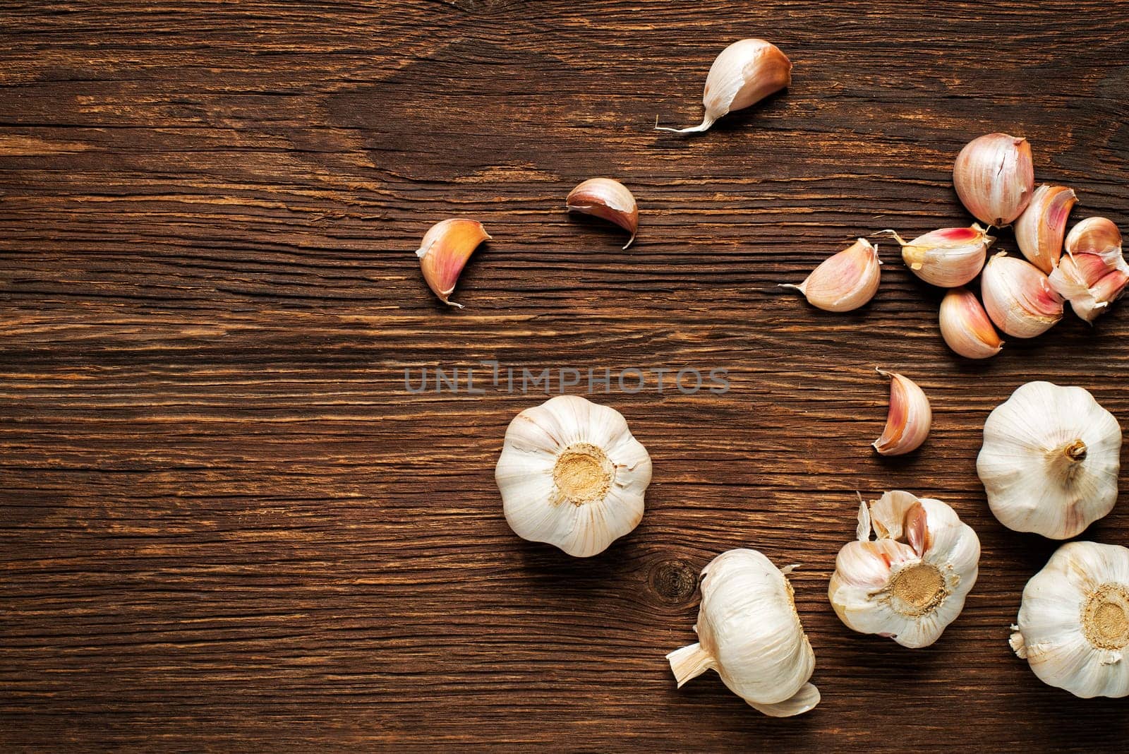 Garlic cloves on wooden vintage background.