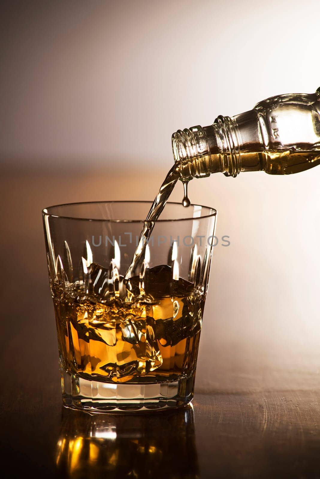 Pouring whiskey into glass close up shoot
