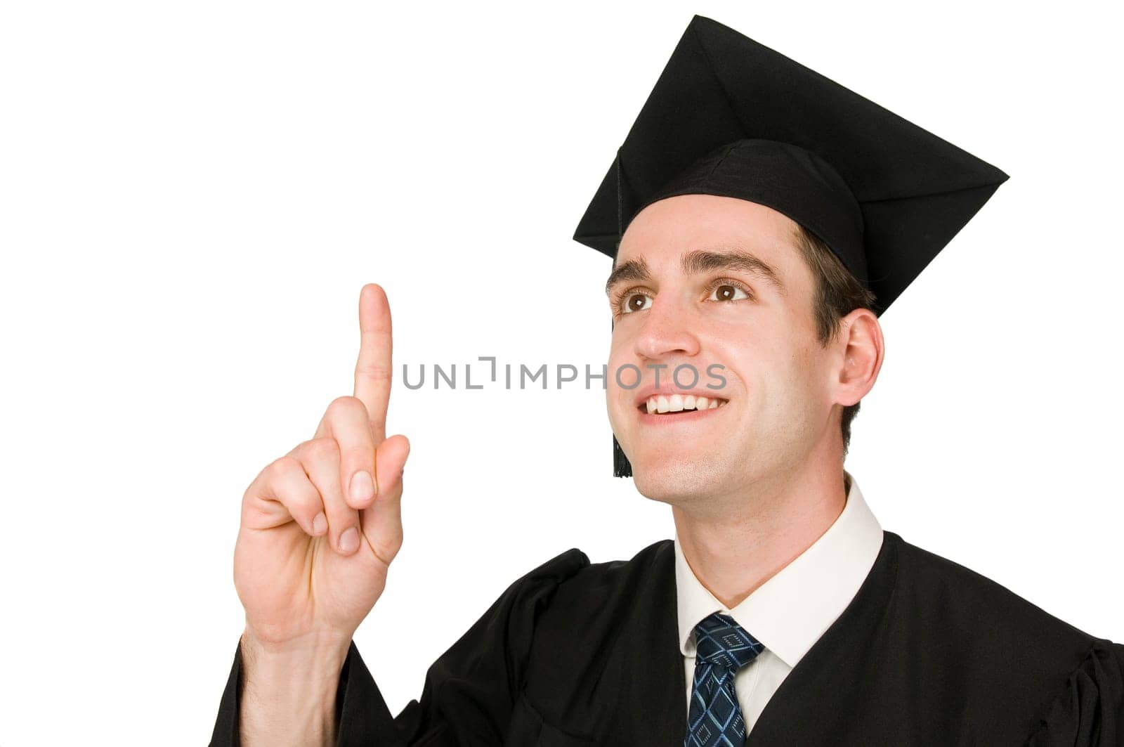 Lateral head-and-shoulder view of a young man in black robe and graduate cap against a white background joyfully knowing raising his index finger.