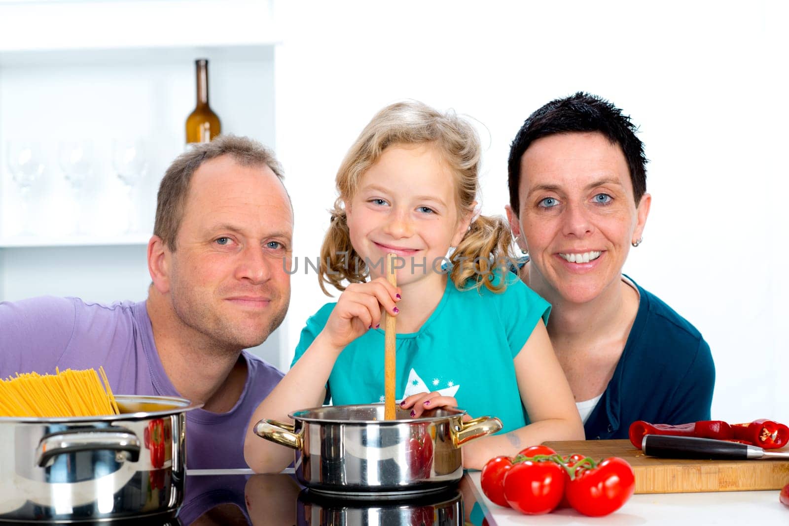 young family cooking together in the kitchen