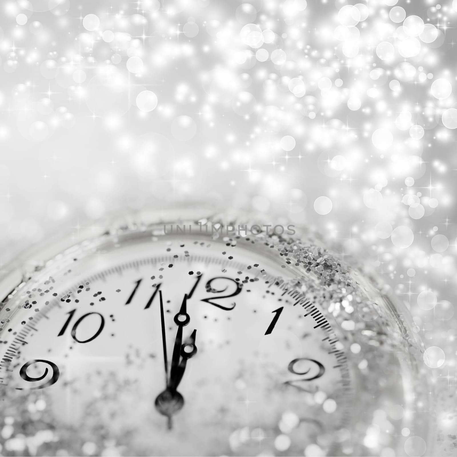 Background of holiday lights and clock close to midnight