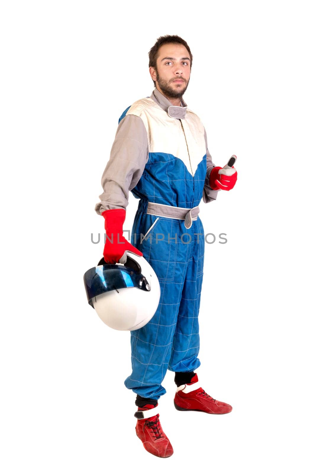 Racing driver posing with helmet isolated in white
