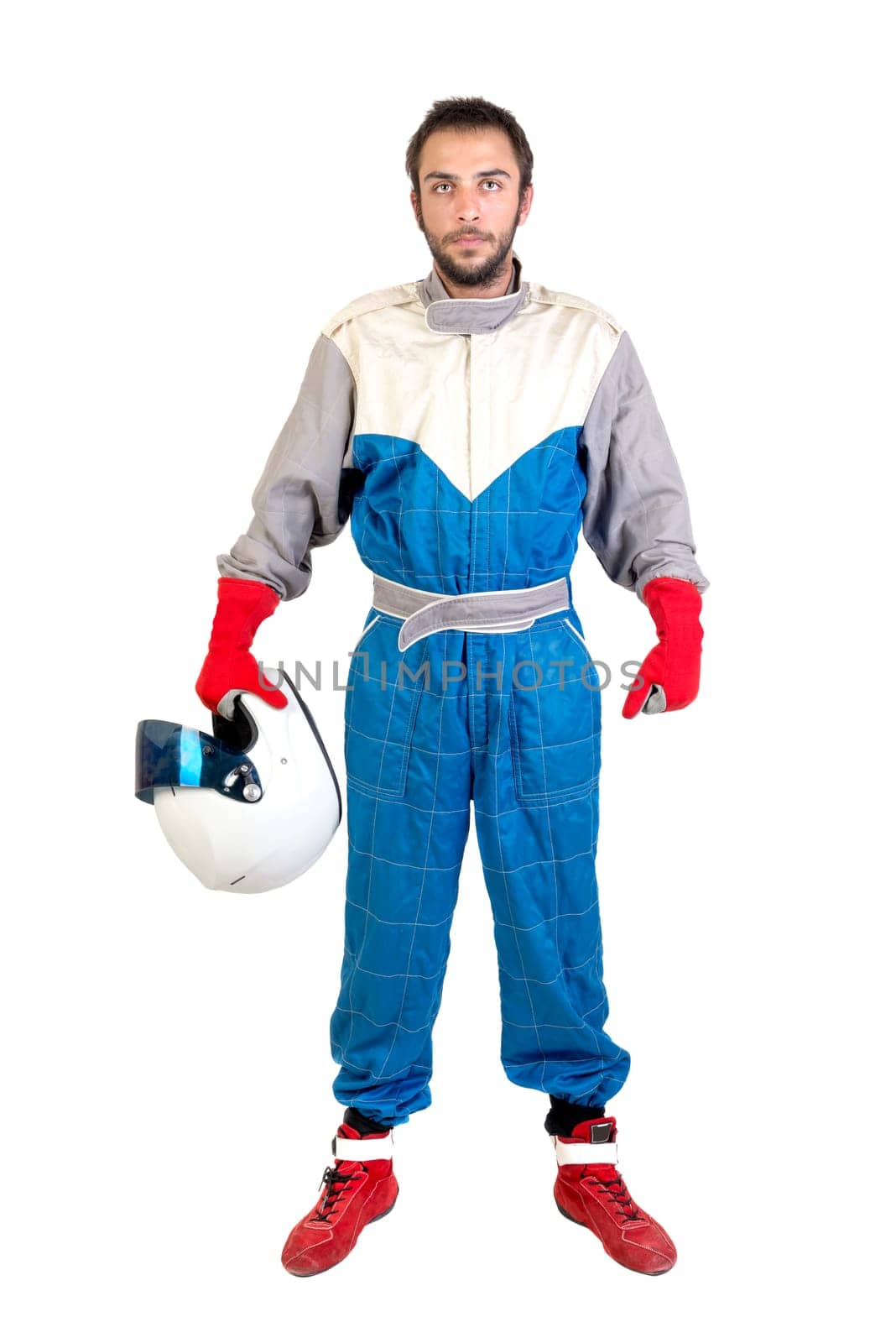 Racing driver posing with helmet isolated in white