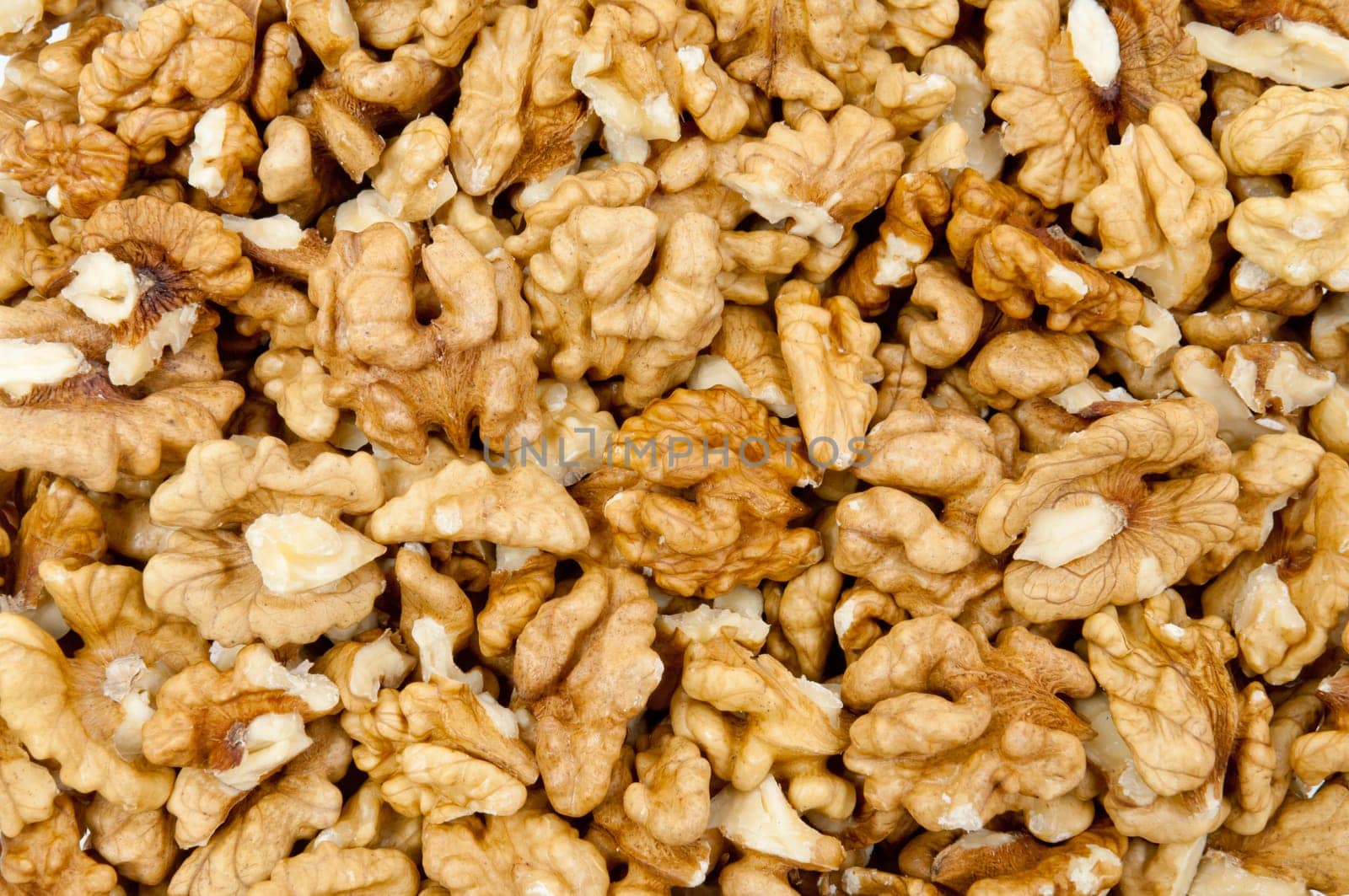 Closeup of shelled walnuts pile as walnut background
