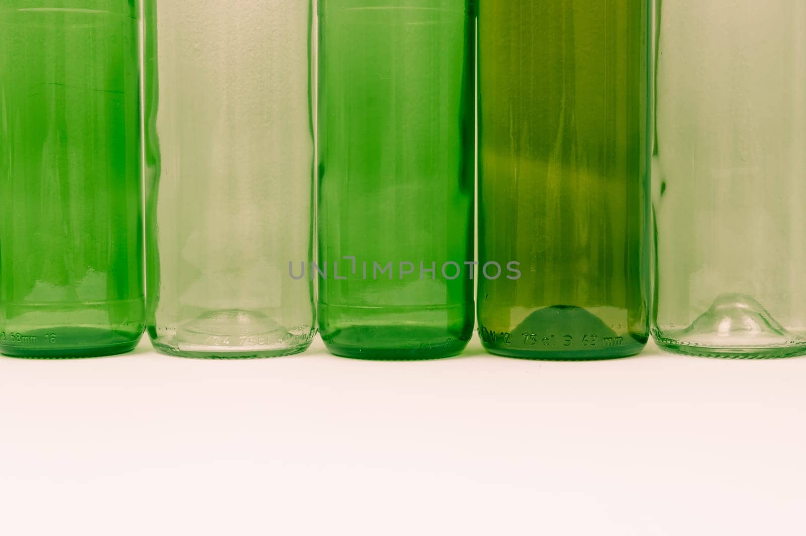Empty glass bottles of mixed colors including green, clear white, brown