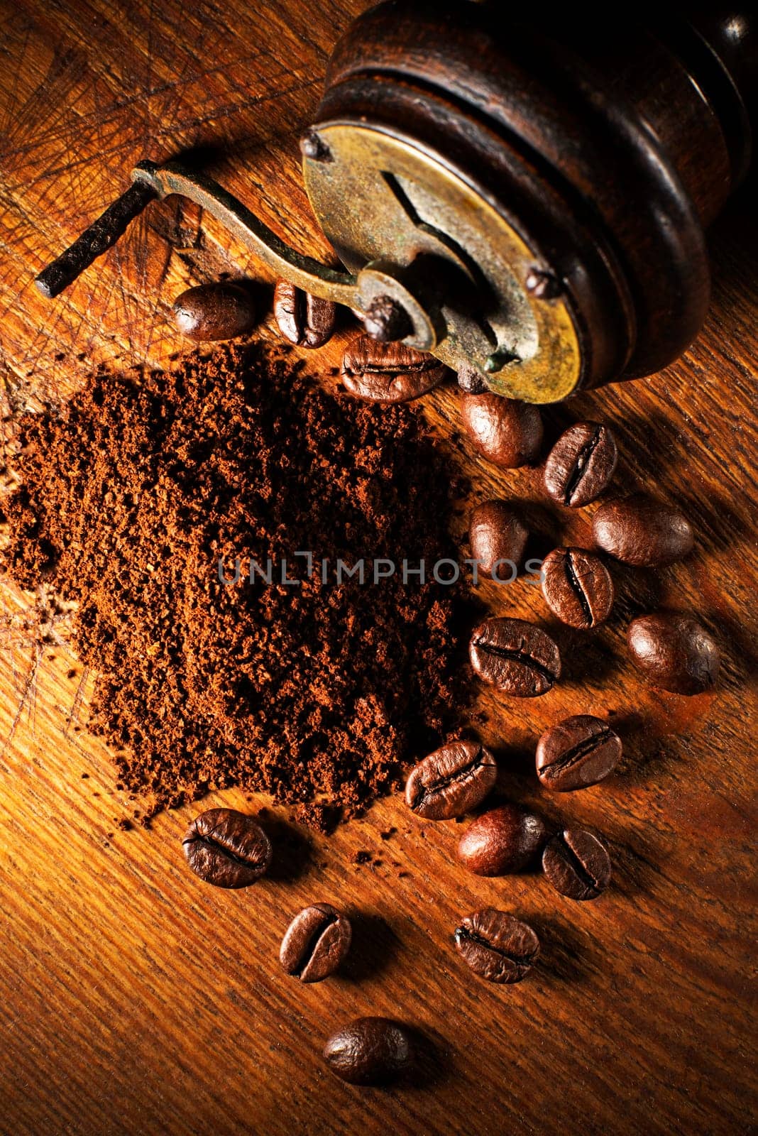 Fresh ground Coffee with hand grinder on wooden background.