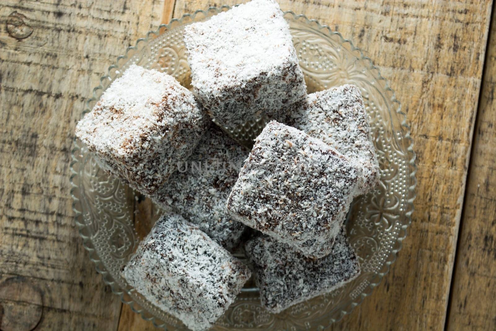 Close up of chocolate cakes with coconut flour on the glass plate