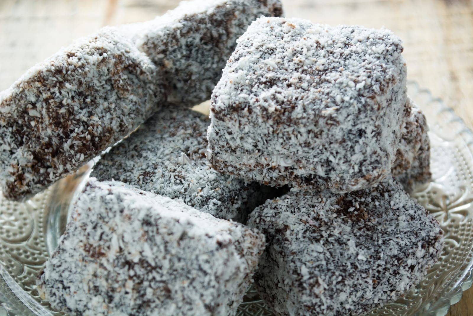 Close up of chocolate cakes with coconut flour on the glass plate
