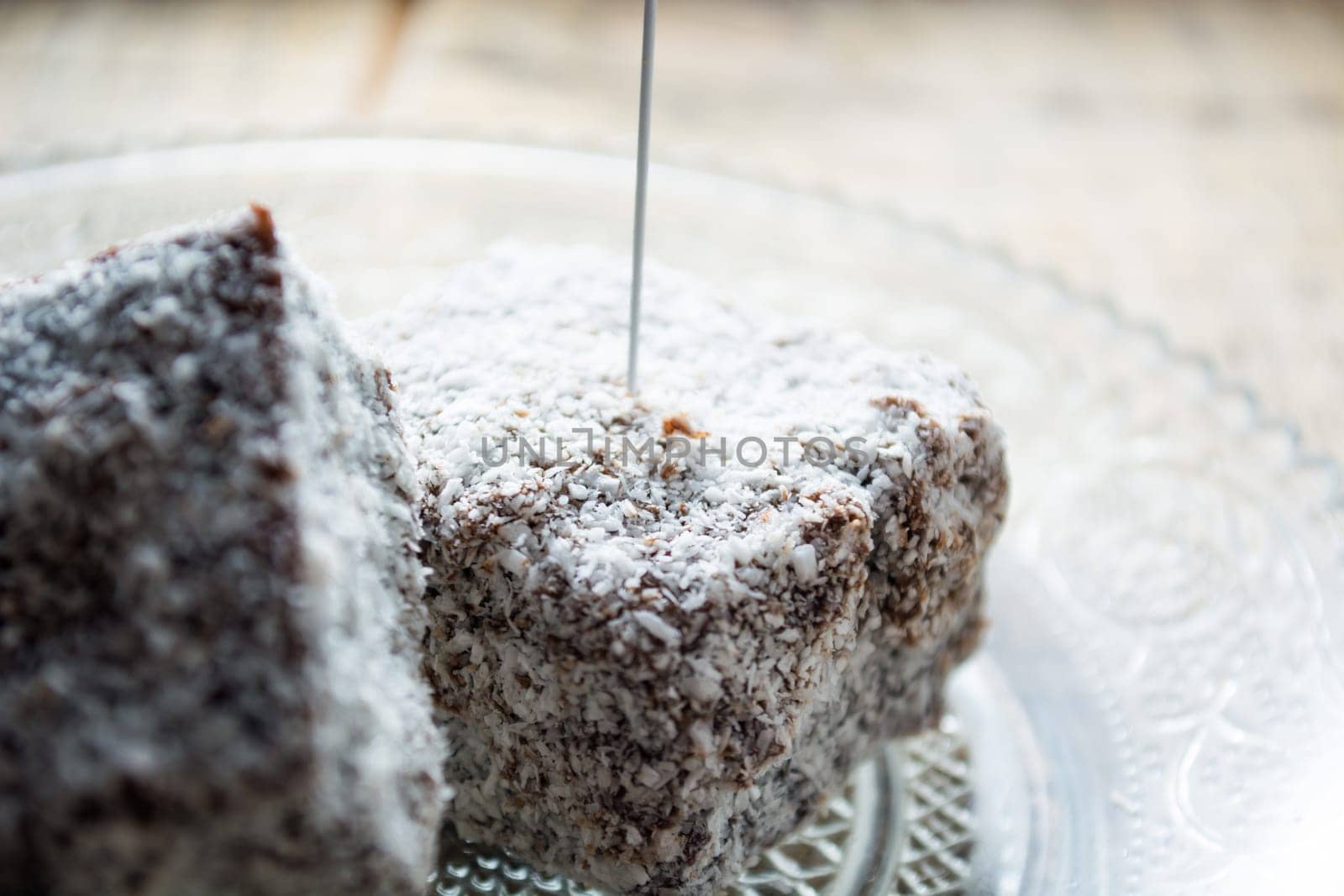 Close up of chocolate cakes with coconut flour on the glass plate