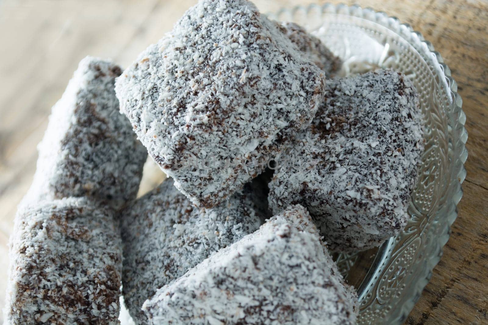 Close up of chocolate cakes with coconut flour on the glass plate