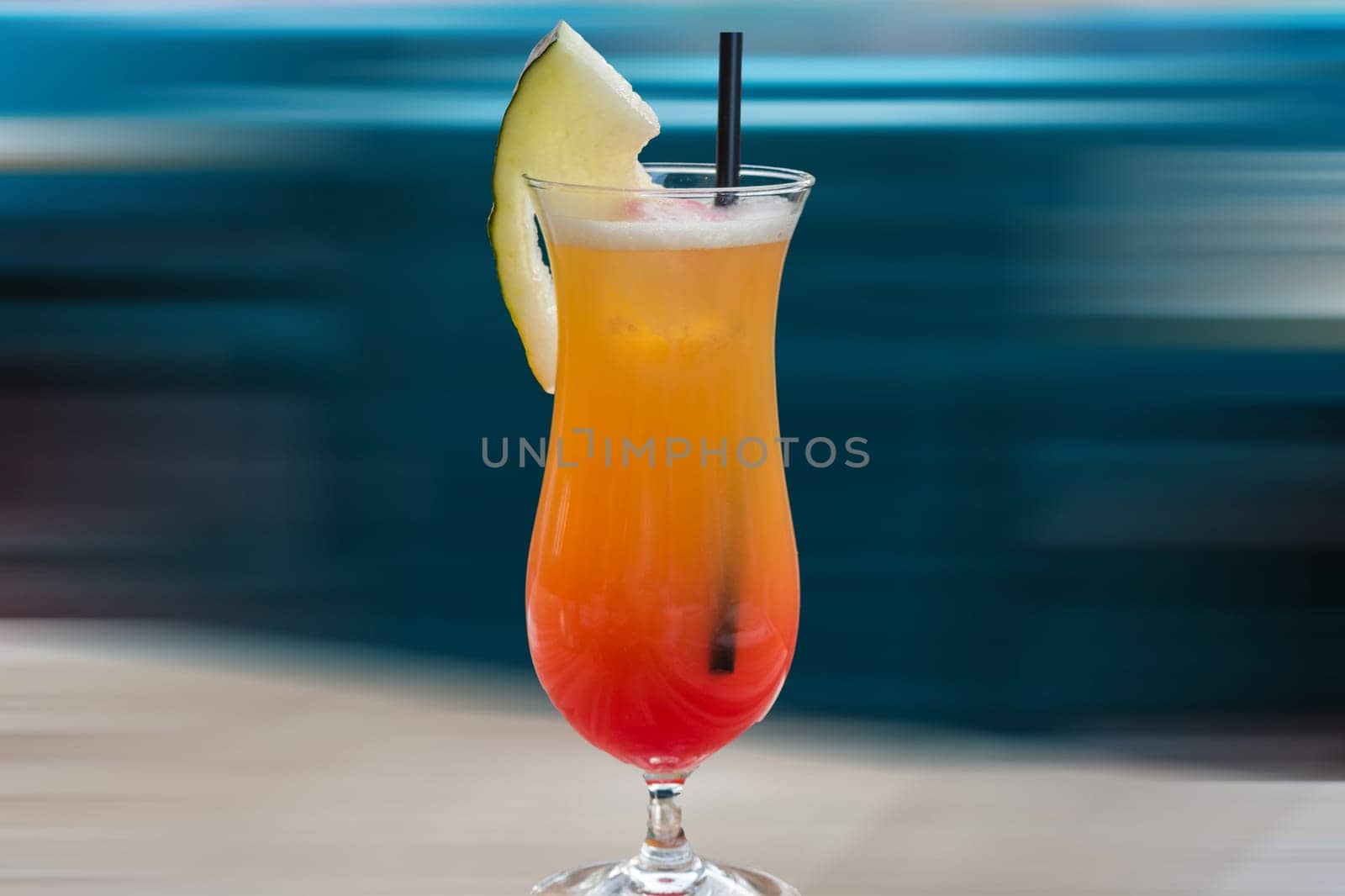 Colourful cocktail on the table of a bar in the restaurant. Background with motion blur..