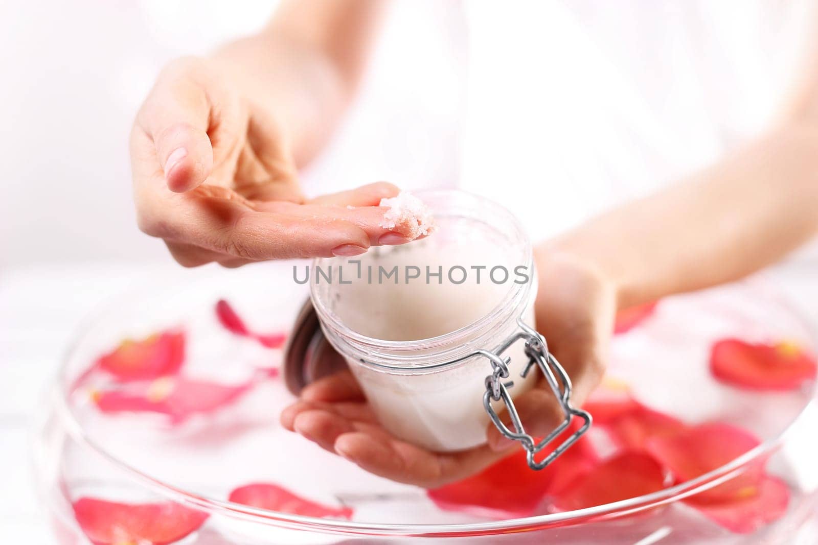 Cosmetic procedure,hand scrub. Beauty salon,manicure with hand scrub Jar with a cosmetic preparation spa & wellness. Massage of women's hands with spa peeling preparation & wellness