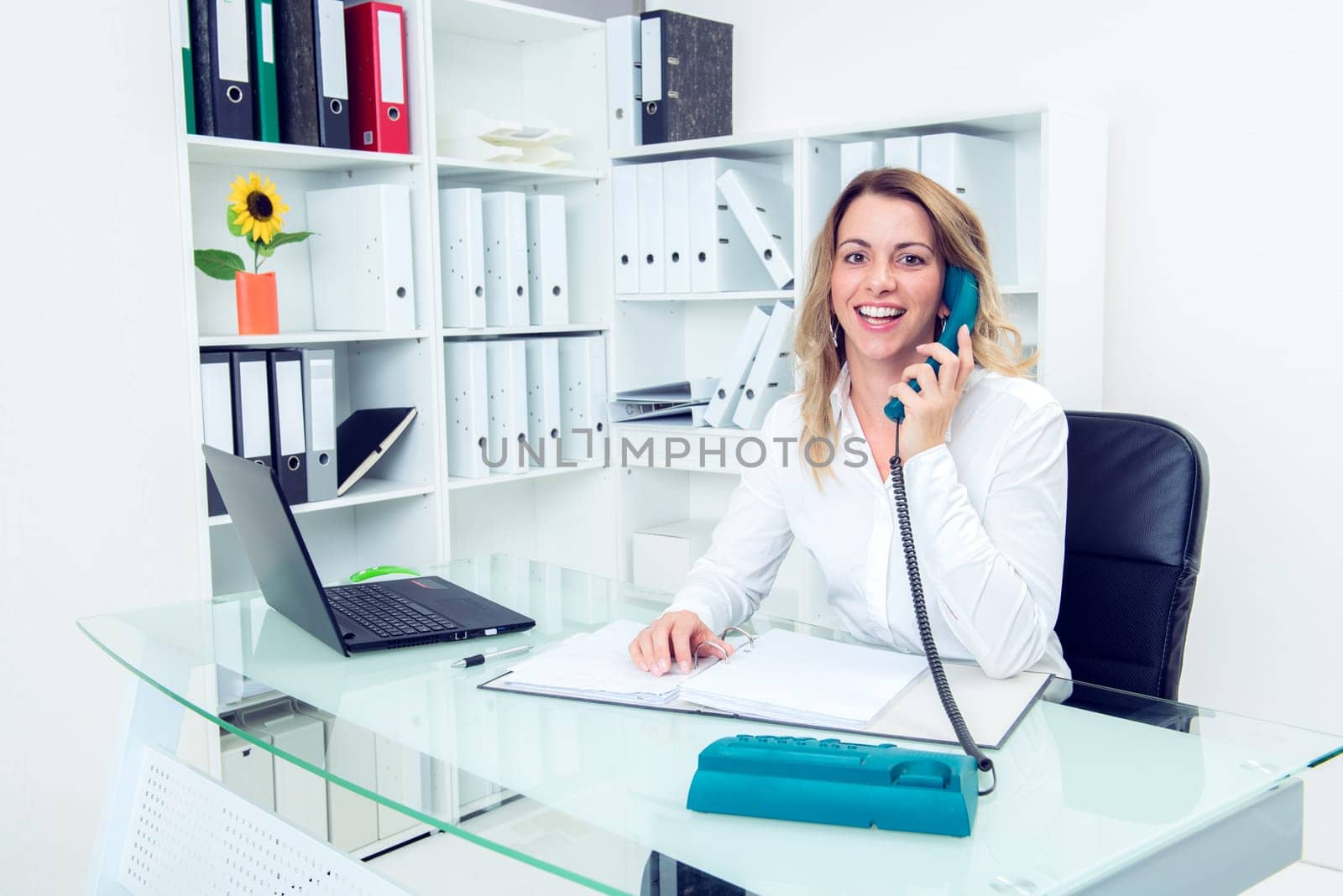 young blond businesswoman calling in the office