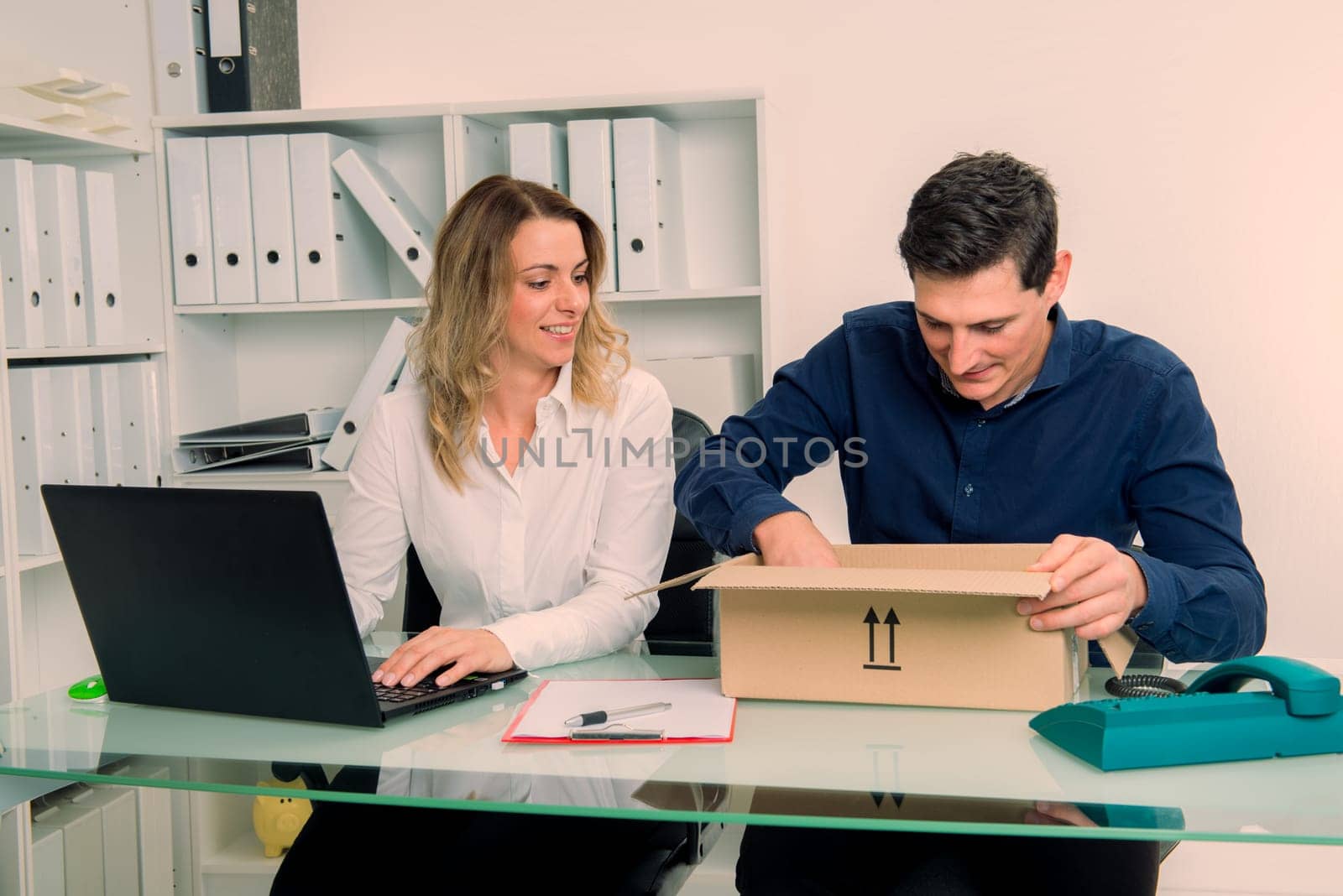 young businessman and businesswoman with delivery in the office