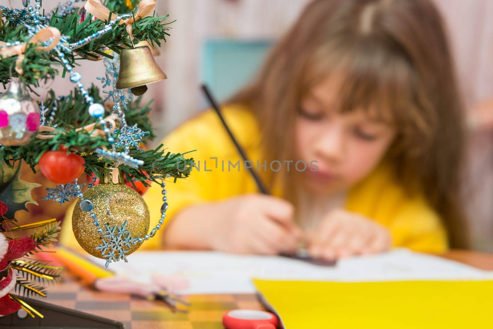 Carried away by a girl making Christmas crafts, focusing on the fur-tree