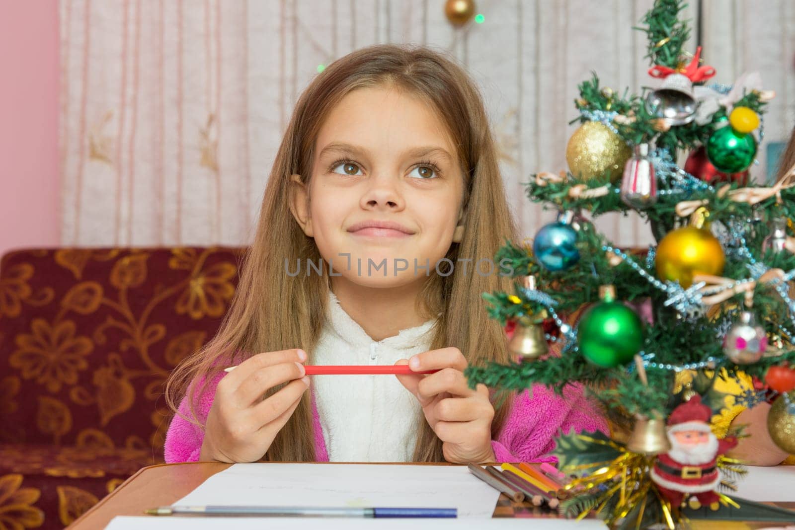 Happy little girl thinking of a gift for the new year