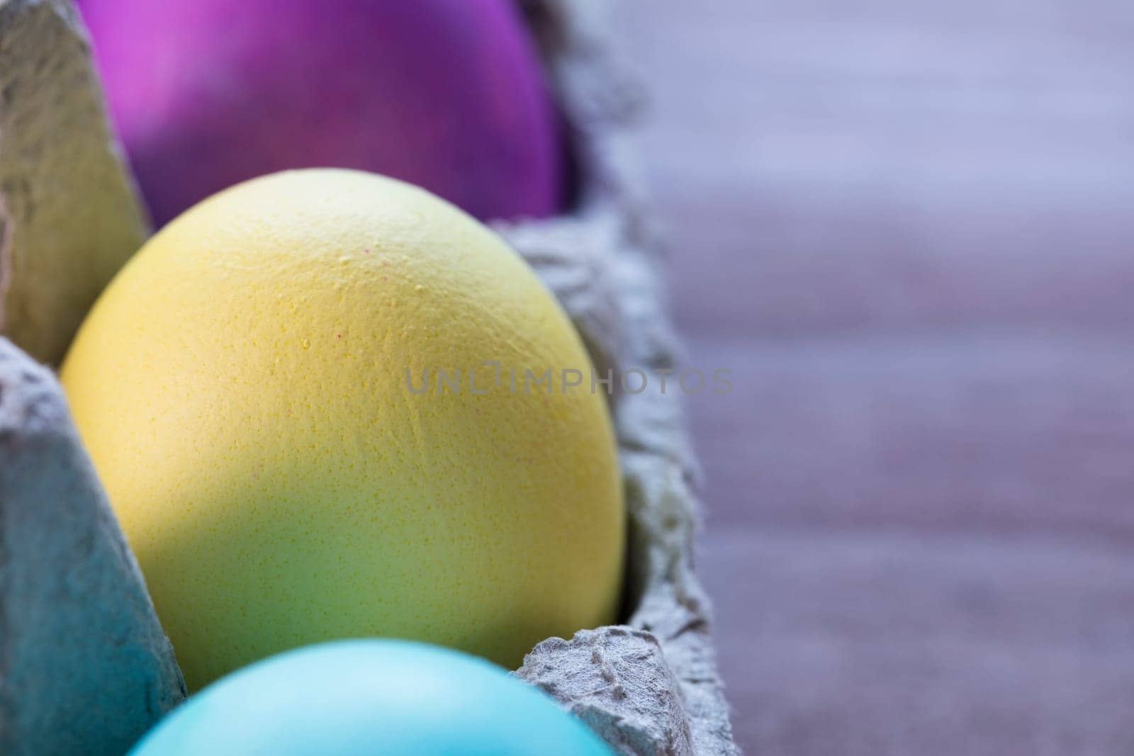Colorful Easter eggs in egg carton.