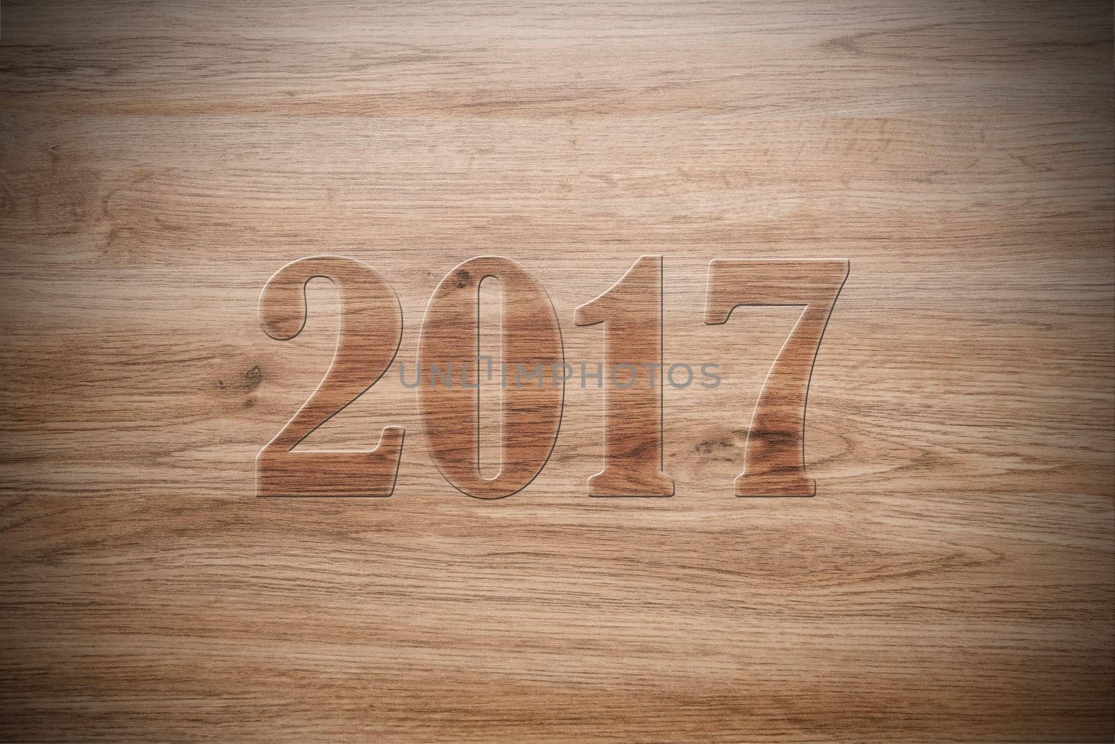 new year- 2017 on brown wooden ground