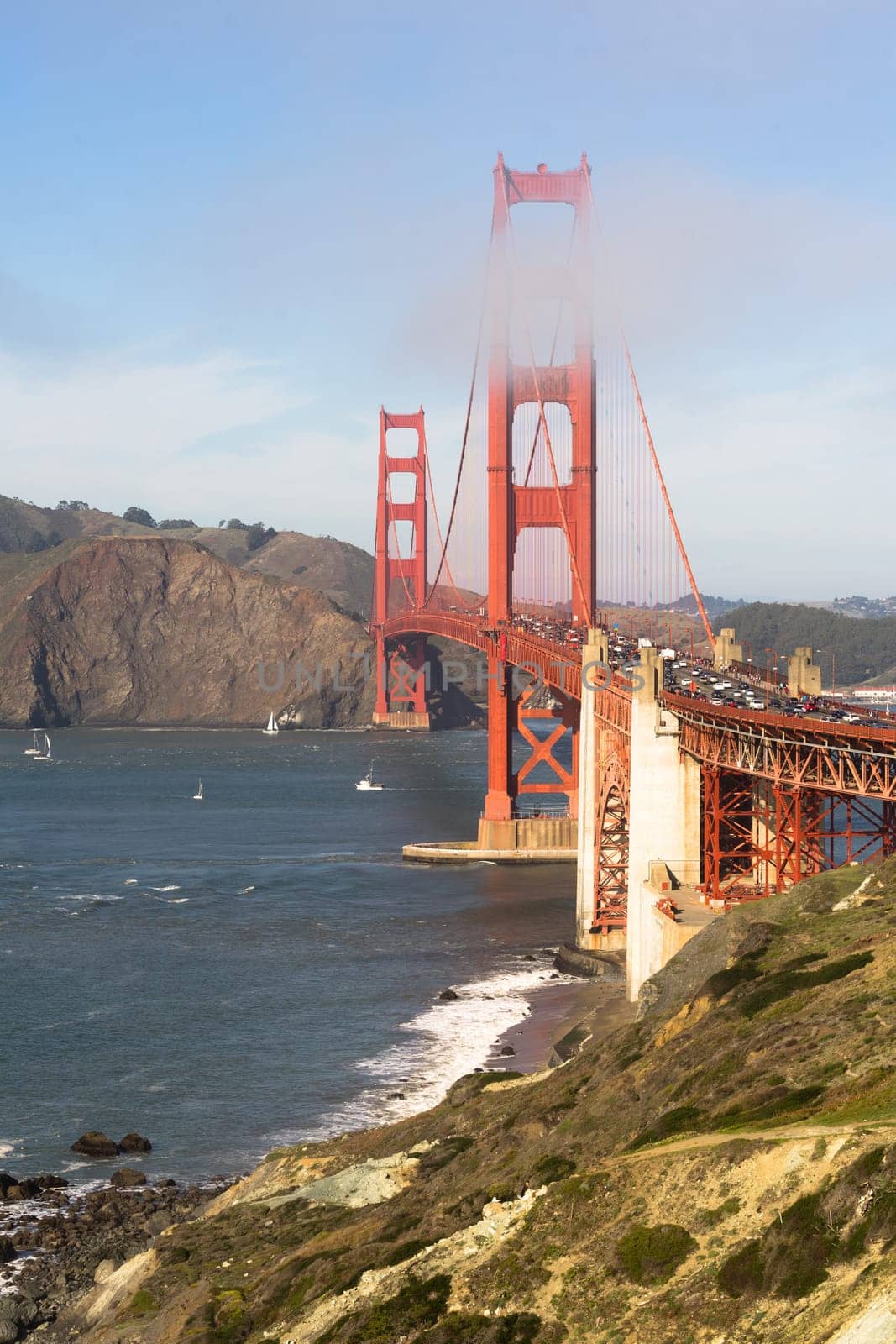 Travelers go on, under, and over the Golden Gate Bridge in San Francisco