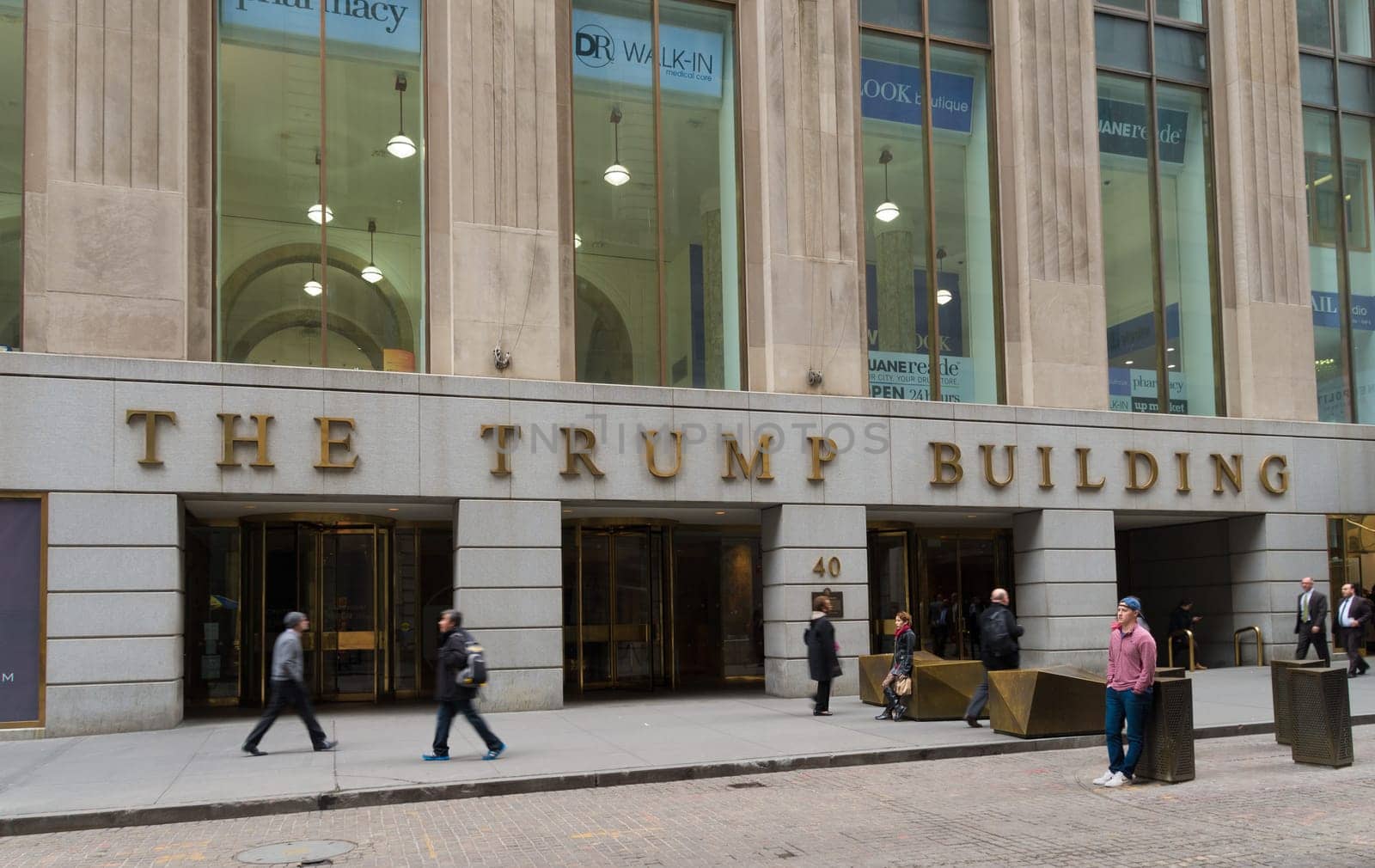 NEW YORK - APRIL 27, 2016: Entrance of the Trump building with unknown people in front of it