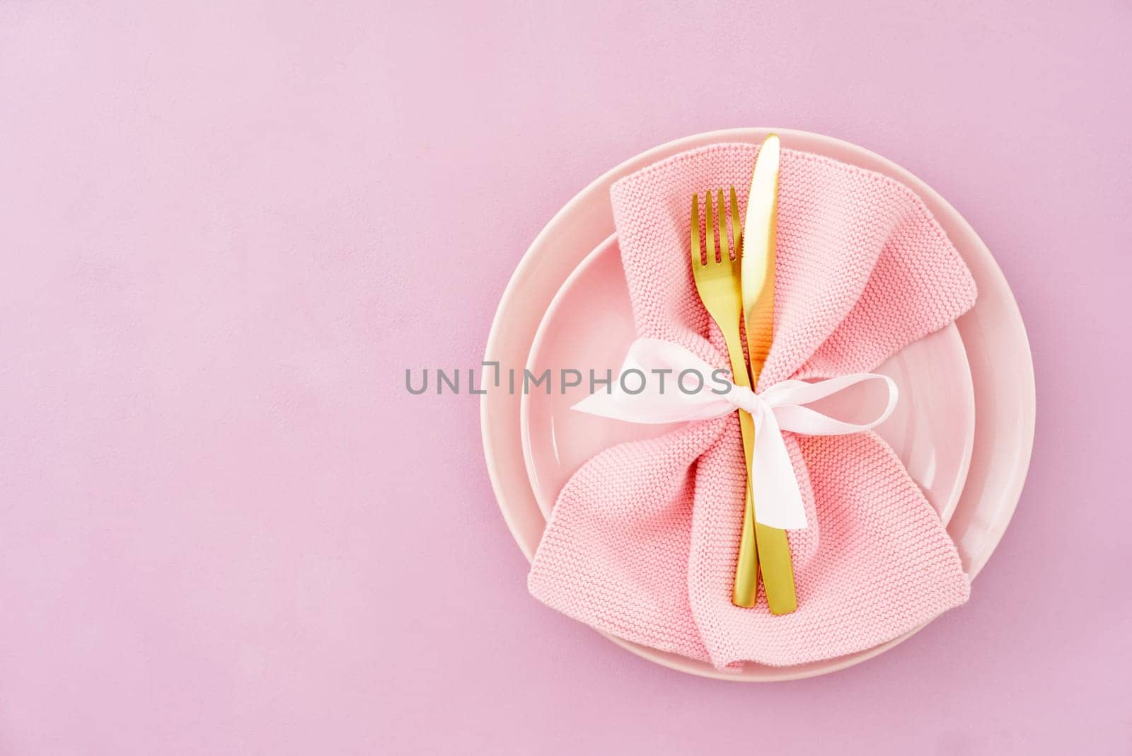 Christmas place setting in pink with golden silverware